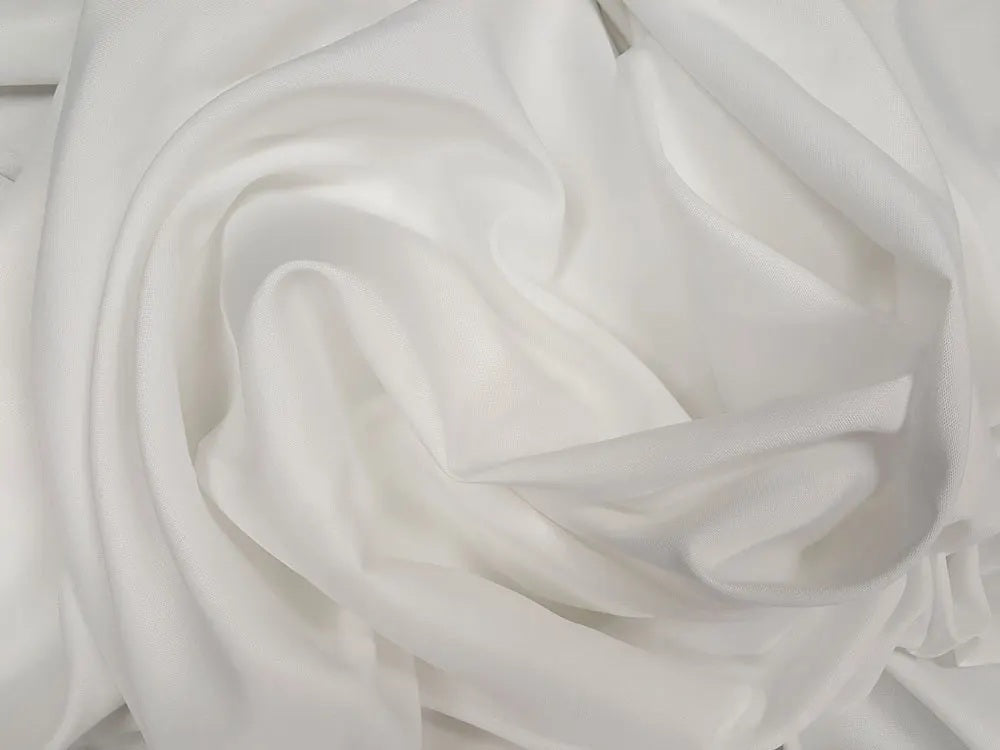 Ivory table linens elegantly draped over reception tables—wedding and party linen rentals ideal for coordinators and event planners.